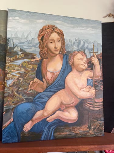 Customer's completed Madonna Yarnwinder paint by numbers artwork showing Mary and the infant Christ against a detailed landscape.