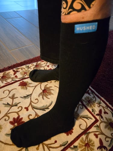 Customer wearing the black knee-high Performance Eucalyptus Compression Socks, showing the smooth fit.
