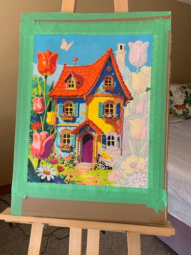 Customer's 'Dream Cottage' paint by numbers kit in progress. The left half is a colorful painting, while the right shows unpainted outlines.