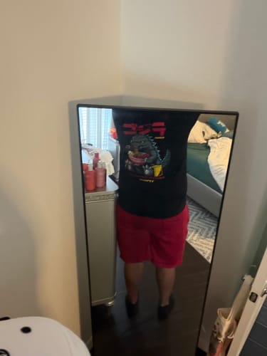 Reviewer taking a mirror selfie while wearing the black RAMEN MONSTER TEE.