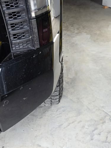 Close-up of a customer's black Tundra, showing the tire flush with the fender after installing 1-inch wheel spacers.