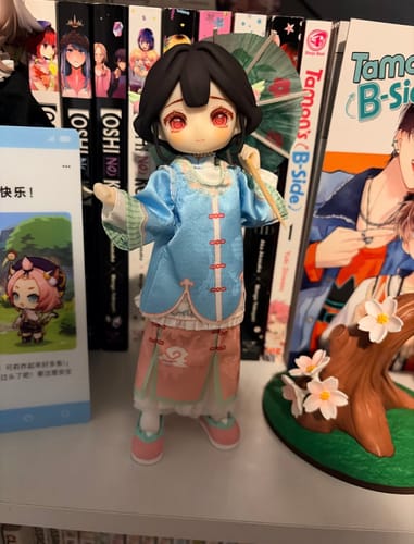 Customer's Nagi Windrider action figure in a blue outfit, holding a small paper umbrella on a shelf.