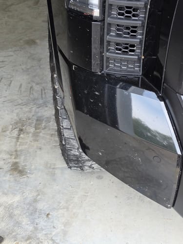 Close-up of a customer's truck tire before installing the 1-inch wheel spacers, showing its stock position.