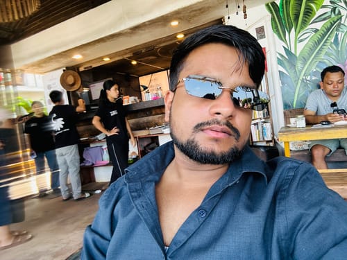 Reviewer's selfie wearing the Underdog black rimless rectangle sunglasses indoors.