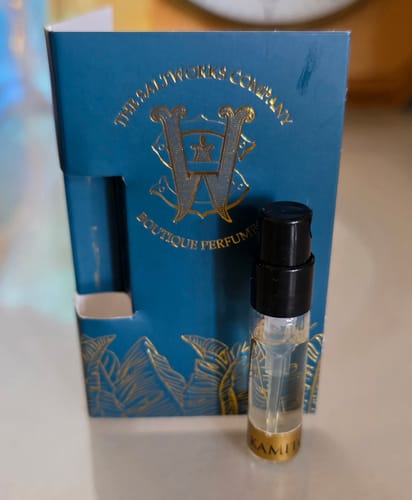 Customer's Kami Tonka perfume sample shown with its decorative teal and gold card sleeve.