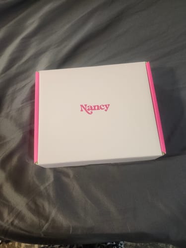 Reviewer's white and pink box containing the Lem Clitoral Massager.