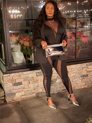 Reviewer in a full-body view wearing the Pinstripe Suited Blazer with a black bodysuit and silver accessories.