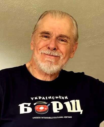 A smiling reviewer in a casual headshot.