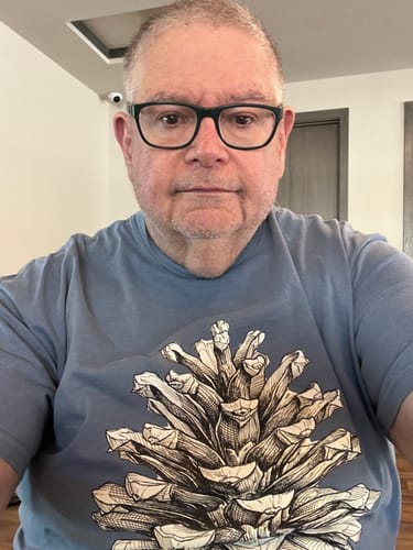 Reviewer wearing the blue Pinecone T-Shirt, showing the large, detailed graphic on the front.