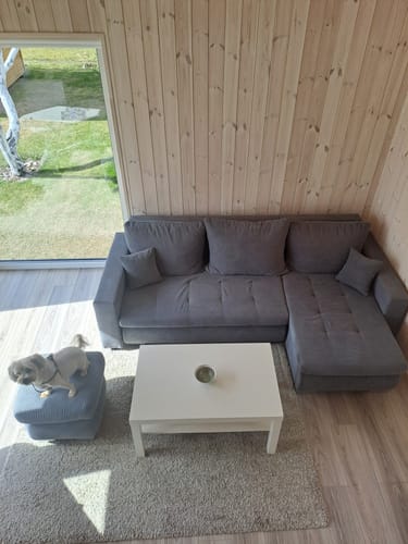 Kliento pilkas minkštas kampas LOKO, matomas iš viršaus, kambaryje su šviesaus medžio sienomis.