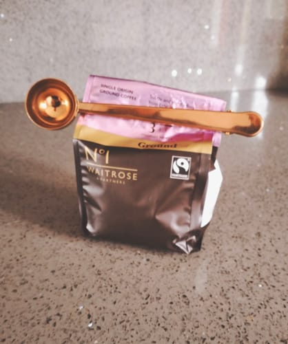 Customer's shiny rose gold Spoon Sealing Clip used to seal a bag of coffee.