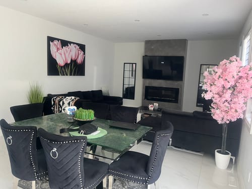 Customer's London shipping painting of pink tulips displayed in a bright living and dining room area.