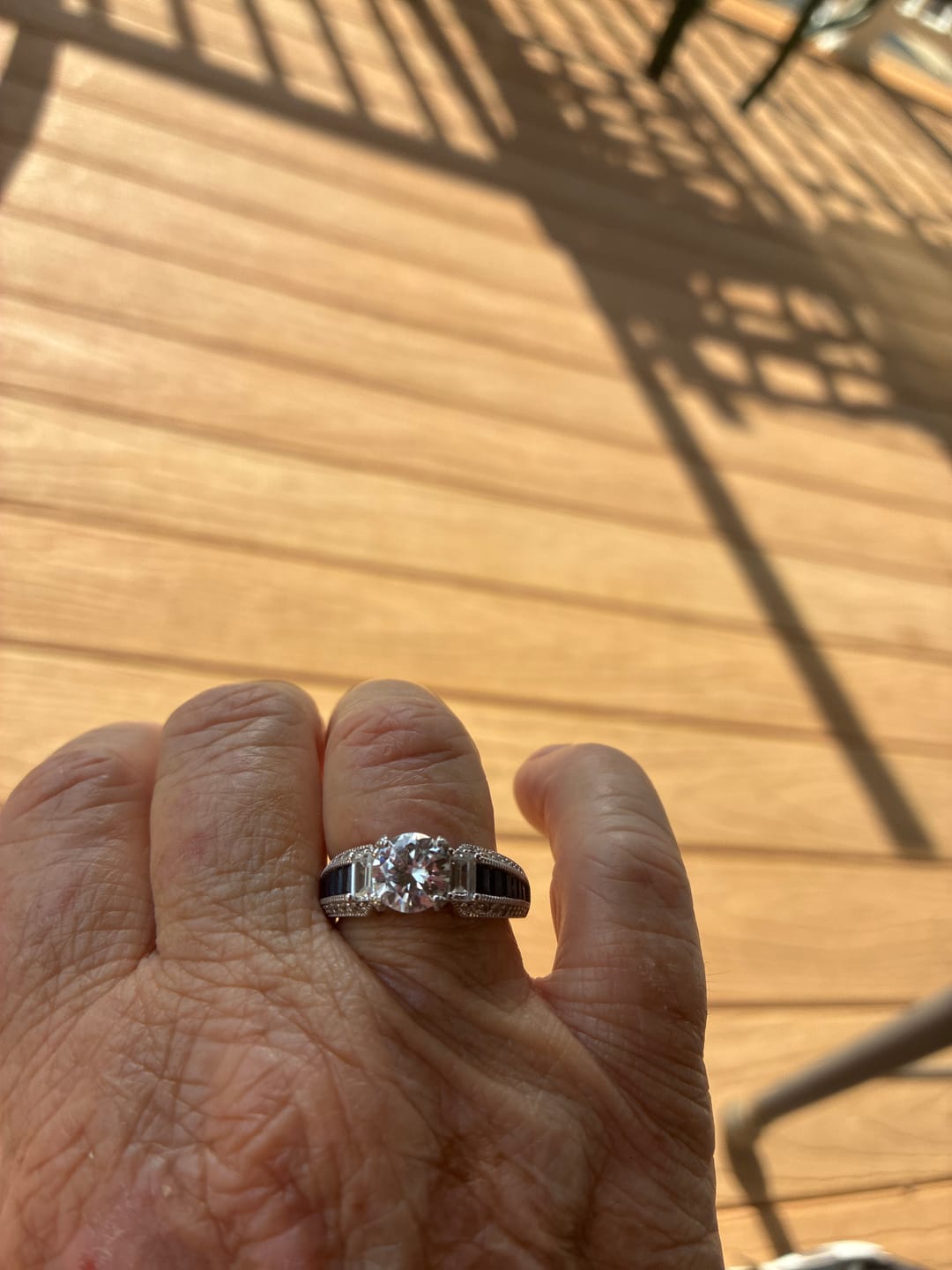 Customer photo review of Round Moissanite And Emerald-Cut Sapphire Channel Set Milgrain Engagement Ring