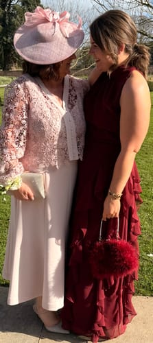 Customer wearing a gold-tone link bracelet with a formal dress.