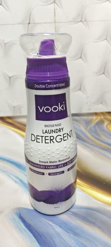 Customer's bottle of VOOKI BioSense Laundry Detergent, showing the purple cap and clear measuring cup.