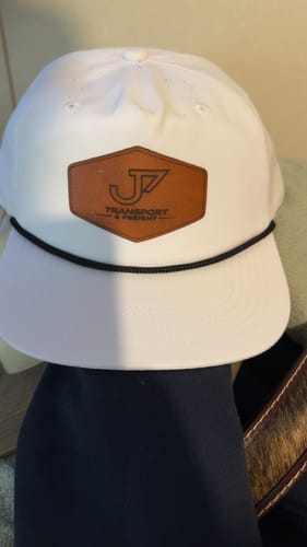 Customer's white 5-Panel Rope Hat with a custom brown leather patch on the front.