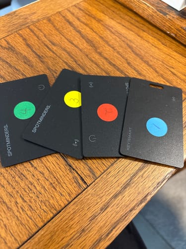 Reviewer's four SPOTMINDERS tracking cards laid on a table, customized with colored and numbered stickers.