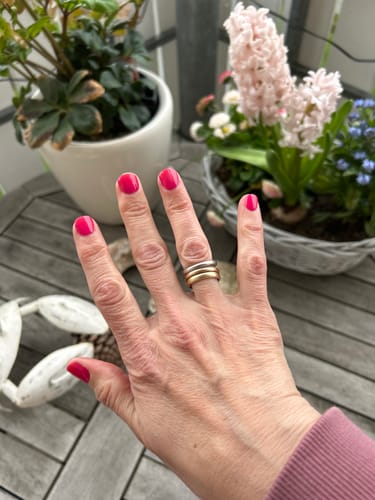 Kundenbewertung für Hunter Ombré UV Gel, die eine Hand mit leuchtend pinken Nägeln zeigt.