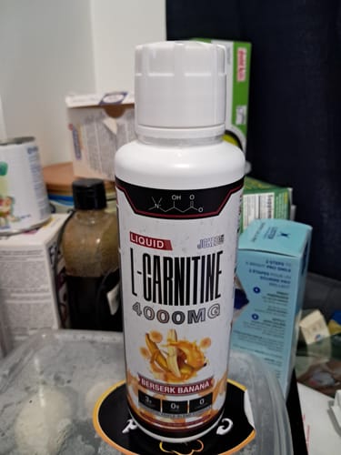 Customer's bottle of Liquid L-Carnitine 4000MG in the Berserk Banana flavor, shown on a counter.
