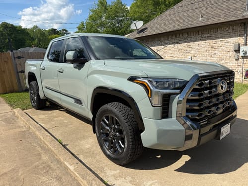 A reviewer's light gray Toyota Tundra with a wider wheel stance after installing 1.5-inch wheel spacers.