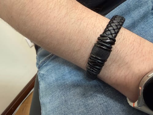Reviewer wearing the black braided bracelet on their wrist, showing the detailed clasp and band.