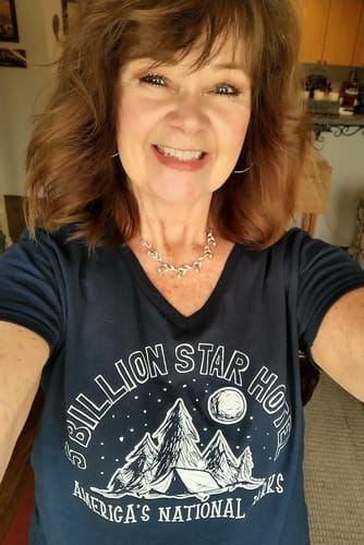 Customer smiling while wearing the dark Five Billion Star Hotel Women's V-Neck Tee.