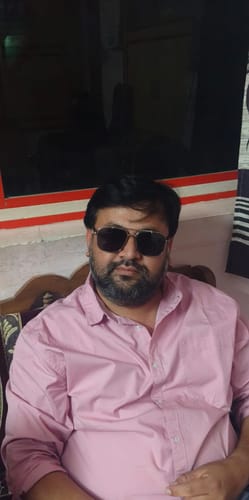 Customer wearing the Co-Pilot Black & Silver Wayfarer Sunglasses while sitting indoors.