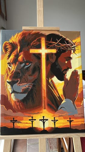 Customer's finished paint-by-numbers artwork of a lion and Jesus, showing a clean result on an easel.
