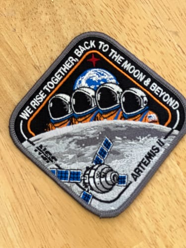A customer's embroidered Artemis II - Collectors Patch displayed on a wooden surface.