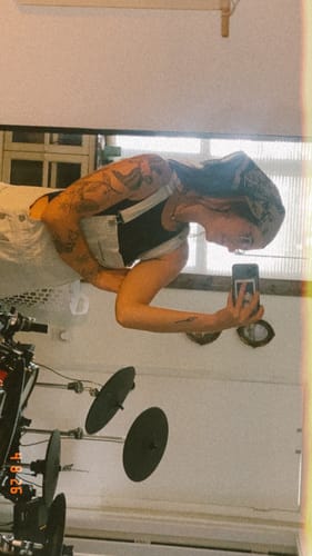 Reviewer wearing the Bramble Bandana on their head while taking a mirror selfie.