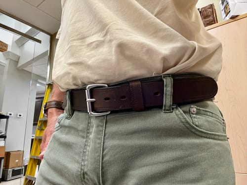 Reviewer wearing the thick, dark brown Old World Harness belt with light green pants.