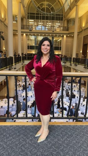 Customer wearing the burgundy Aless V Neck Front Twist Velvet Mini Dress at a formal event.