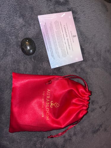 Reviewer's VIP Crystal Club shipment with a labradorite stone, a red satin pouch, and an information card.