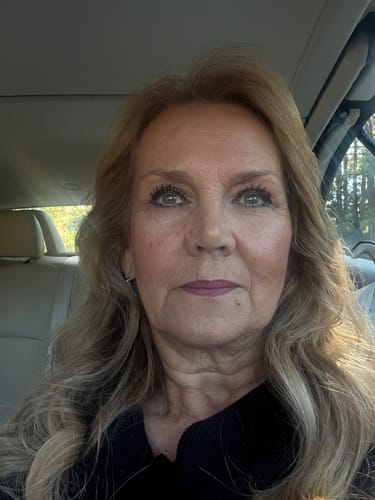 Reviewer in a car showing her long, dark lashes after using My Amazing Lashes Mascara.