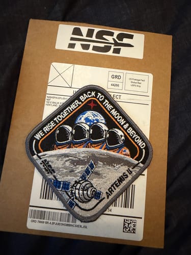 Customer's Artemis II - Collectors Patch displayed on the cardboard mailer it arrived in.