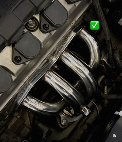 Customer's shiny Shorty Exhaust Header installed in the engine bay of a Honda Civic, showing its clean fit.