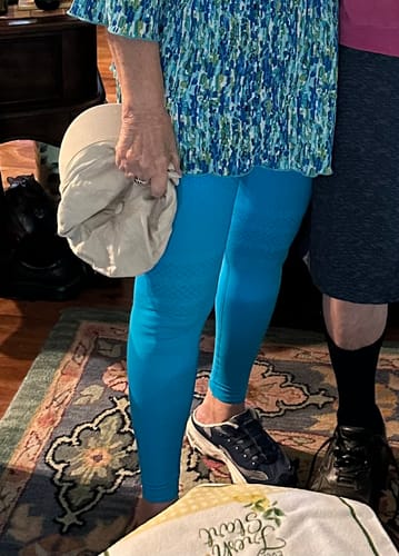Partial view of a customer wearing bright blue 3D Anti-Cellulite Leggings, showing the textured fabric and smooth fit on their legs.