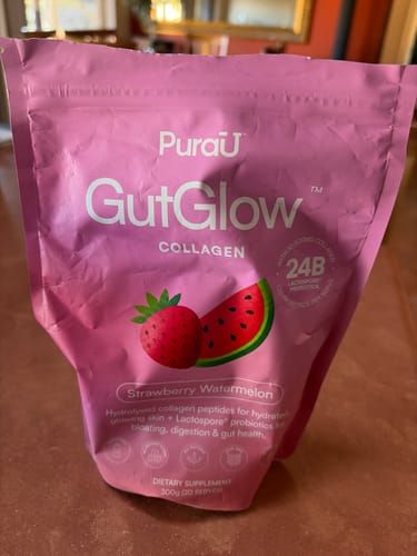 Customer's pink pouch of GutGlow Collagen in Strawberry Watermelon flavor.