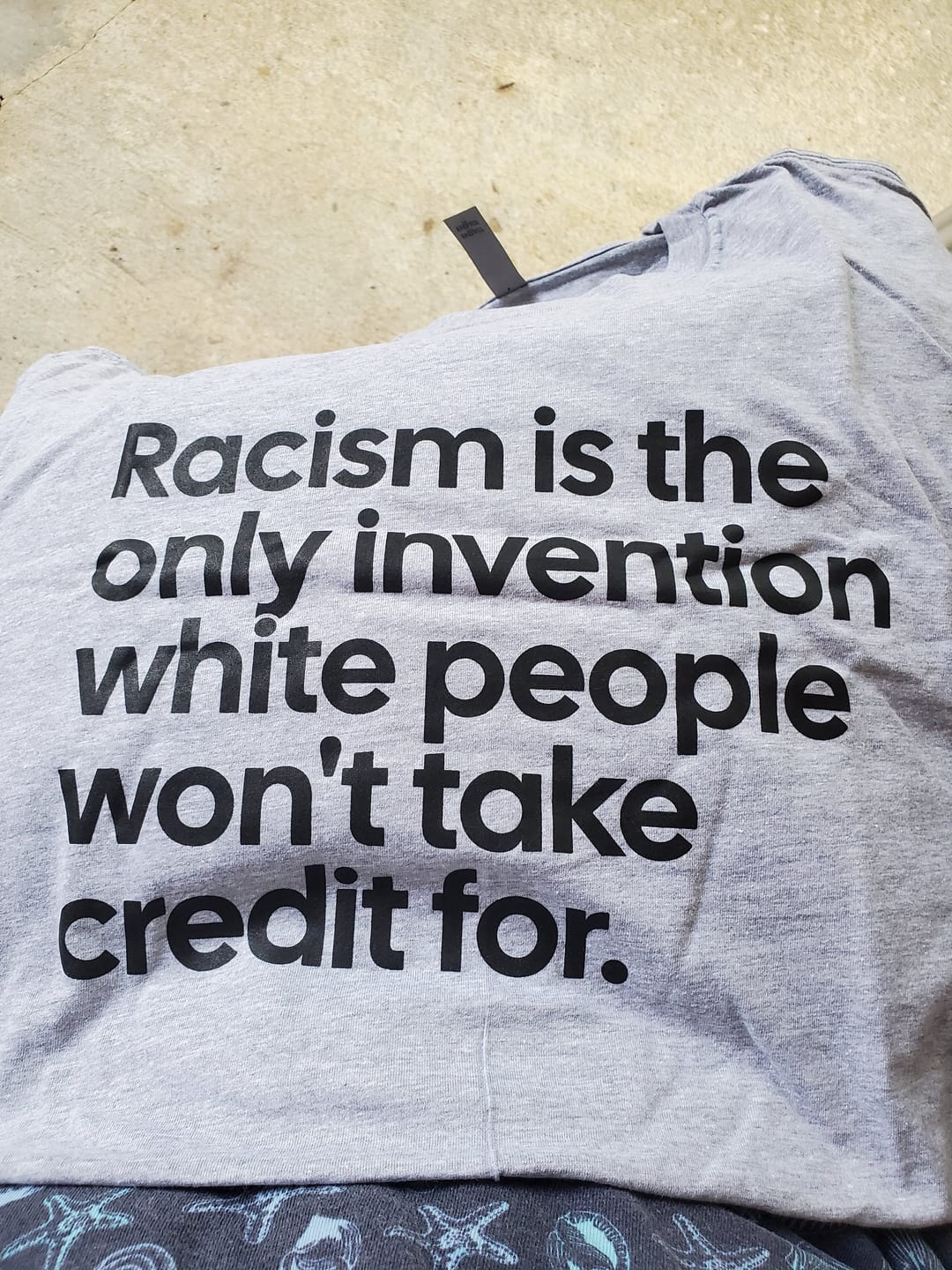 Customer photo review of Racism Is the Only Invention White People Won’t Take Credit For Unisex Tee