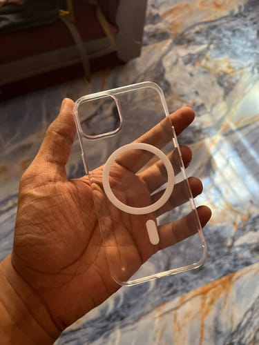 Customer holding the clear Anti Yellow Magsafe Case for iPhone 13 in their hand.