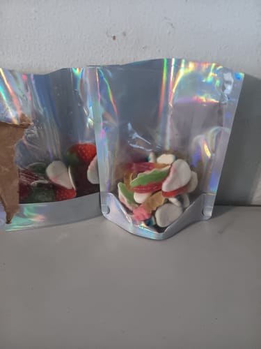 Reviewer's Strawberry and Cream Gummies shown in two shiny, iridescent bags on a table.