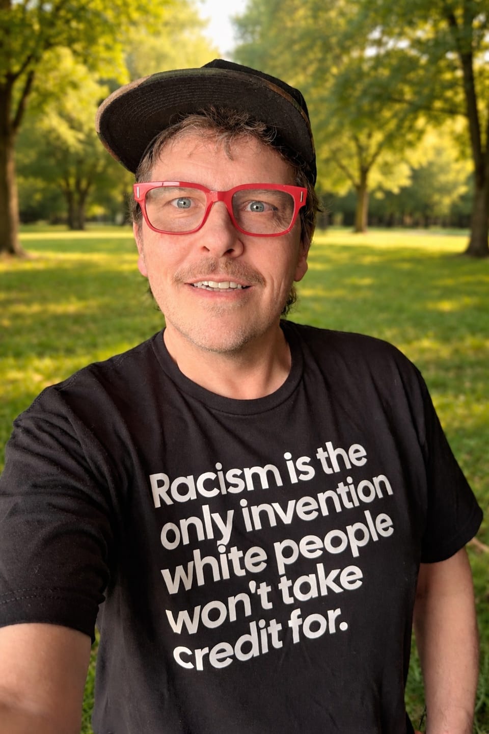Customer photo review of Racism Is the Only Invention White People Won’t Take Credit For Unisex Tee