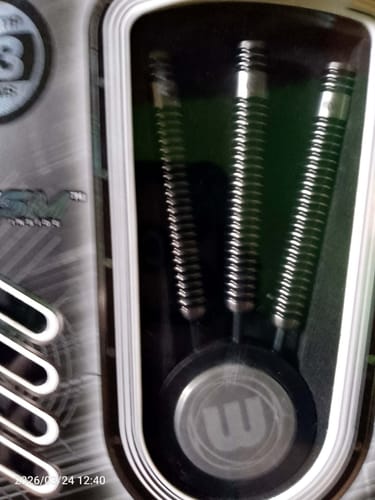 Customer's close-up of the three Winmau Blackout steeltip darts inside their original packaging, showing the grooved barrels.