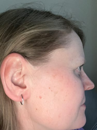 Reviewer's side-profile showing a small, silver hoop earring.