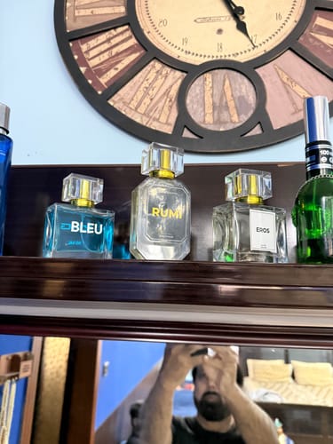 Customer's Eros perfume bottle displayed on a shelf with their Bleu and Rumi fragrances.