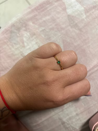 Customer wearing the May Birthstone 18K Gold Ring, showing its delicate band and green stone.