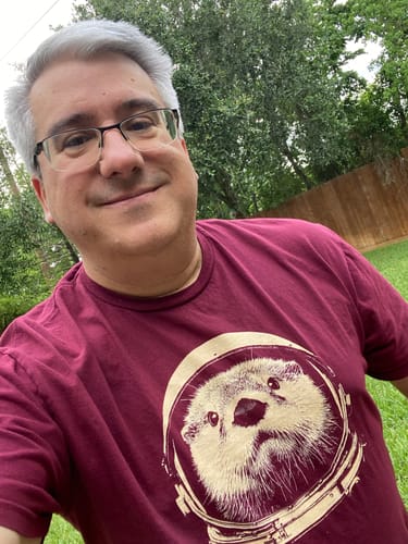 Reviewer wearing the maroon Otterspace t-shirt showing the detailed otter astronaut graphic.