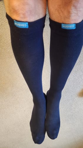 Customer showing the fit of their dark Performance Eucalyptus Compression Socks on their calves.