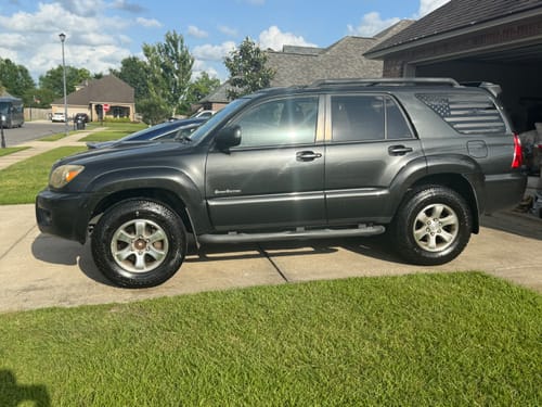 Customer's dark gray Toyota 4Runner in a driveway after installing the 2 Inch Front Leveling Lift Kit.