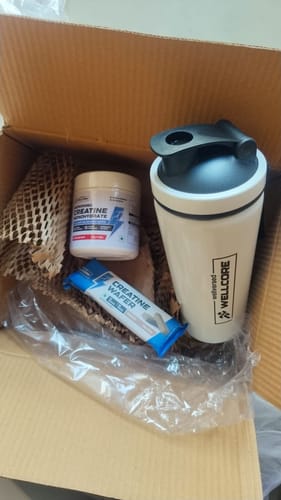 Customer's Wellcore Creatine Monohydrate, a shaker bottle, and a creatine wafer bar inside an open box.
